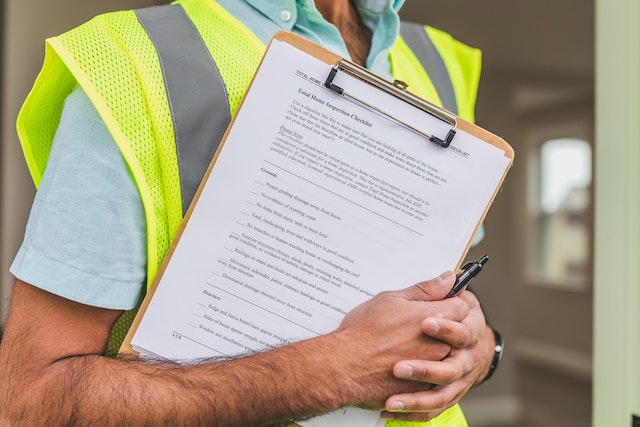 home%20inspector%20holding%20a%20property%20inspection%20checklist